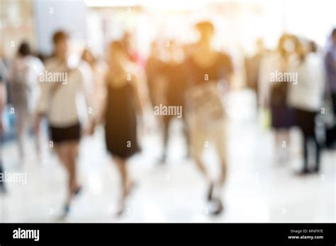 Abstract Blur People Walking And Sunlight Shining From Behind Stock