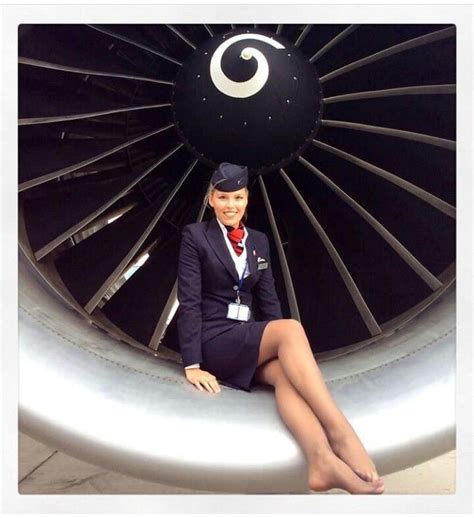 A Woman Sitting On The Side Of An Airplane Engine