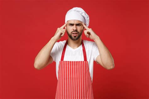Preoccupied Young Bearded Male Chef Cook Or Baker Man In Striped Apron Toque Chefs Hat Posing