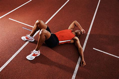 Tired Athlete Man Lying On Running Track Stock Photos Pictures