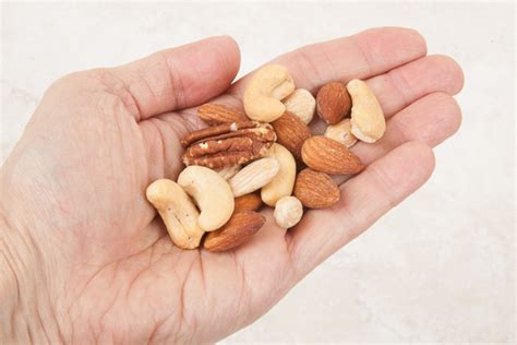 There are 104 calories in 1 oz with shell, yields (0.5 oz) of pecans, raw. Eat a Handful of Nuts Per Day