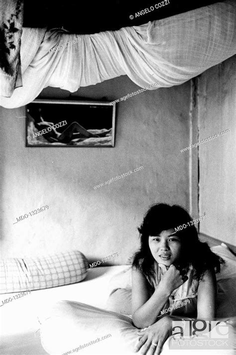a prostitute in saigon a vietnamese prostitute posing while stretched out on a bed in a shabby