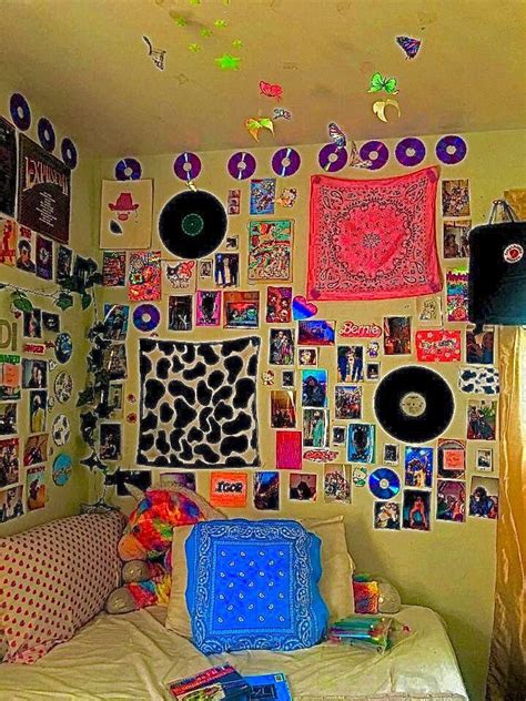 A Bed With Lots Of Pictures On The Wall Above It And Pillows In Front Of It