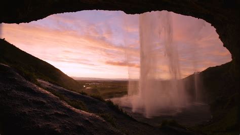Seljalandsfoss Waterfall From Inside A Cave During Sunset Iceland