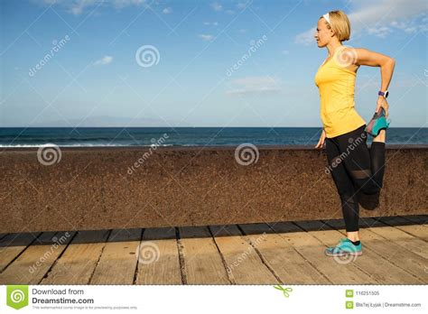 Woman Runner Stretching At The Seaside On Sunny Summer Day Stock Image