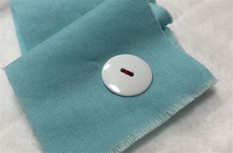 How To Sew A Two Hole Button By Hand