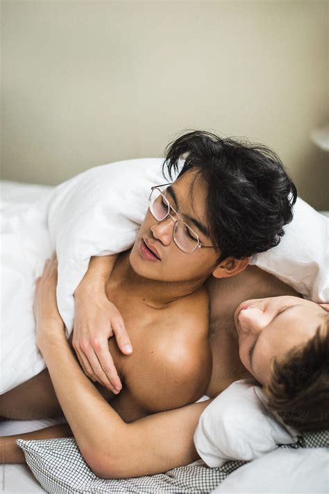 Gay Couple Embracing In Bed Del Colaborador De Stocksy Irina
