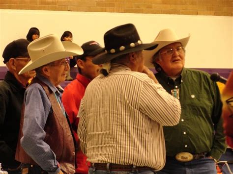 Several Men In Cowboy Hats Standing Next To Each Other