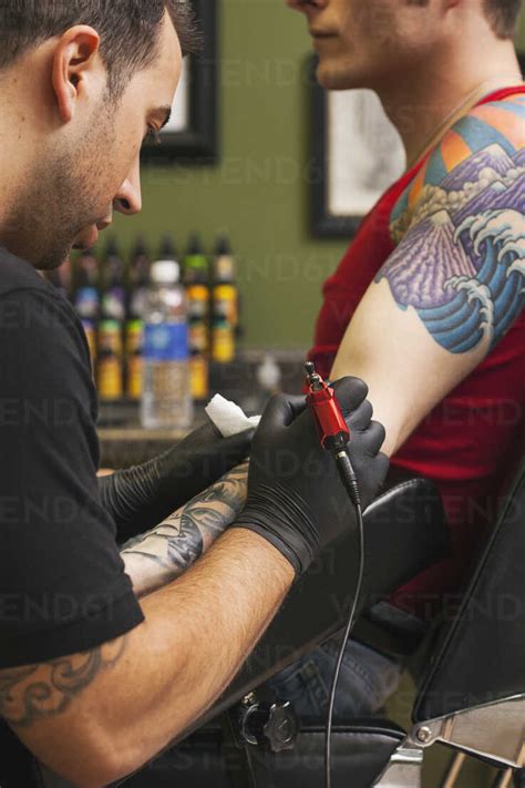 Tattoo Artist At Work Stock Photo