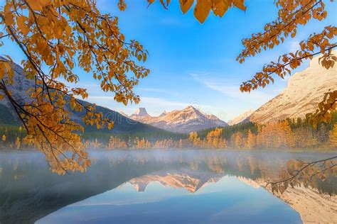 Kananaskis Mountain Lake Framed With Orange Fall Leaves Stock Photo