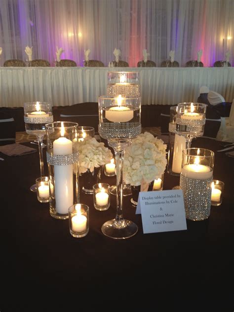 As a florist, wedding centerpieces are my favorite. Candle centerpiece, black and silver wedding, lots of ...
