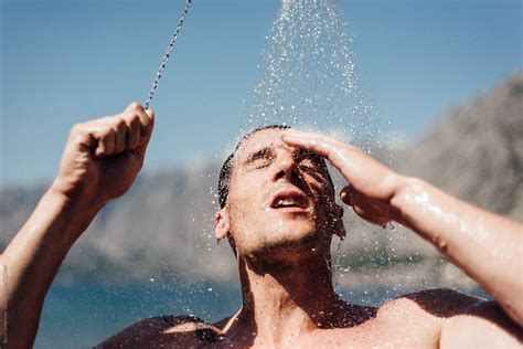 Man Showering At The Beach By Stocksy Contributor Boris Jovanovic