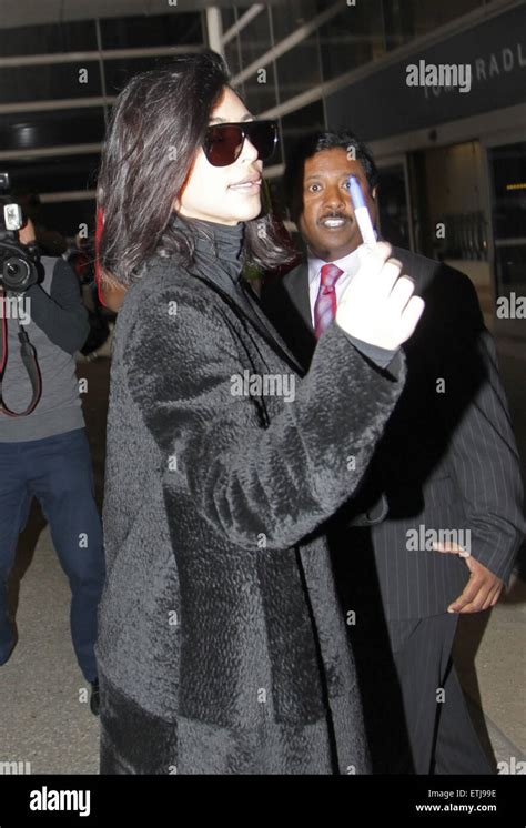 Kim Kardashian West Signs Autographs For Fans Upon Her Arrival At Los