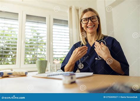 Smiling Female Doctor Talking With Patient Online And Introducing