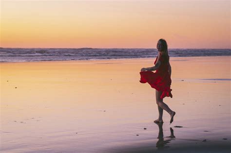Naked Female Posing On The Beach At Sunset SuperStock