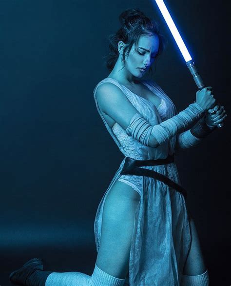 A Woman Dressed As Star Wars Character Holding A Light Saber In Her