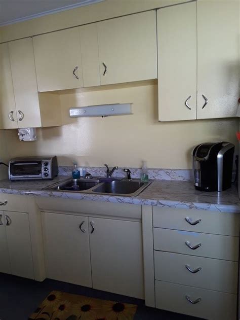 How to spruce up kitchen cabinets. How can I change up old metal kitchen cabinets besides ...