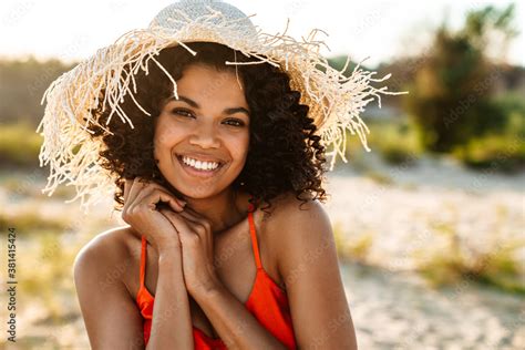 Positive Young African Woman Posing At The Beach Outside Stock Photo