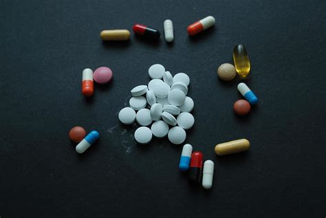 pills on black 12114432 Stock Photo at Vecteezy