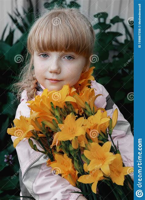 Funny Red Haired Girl With A Bouquet Of Yellow Lilies