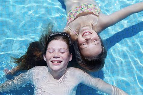 Two Girls Floating In Water Photograph By Ruth Jenkinson Pixels