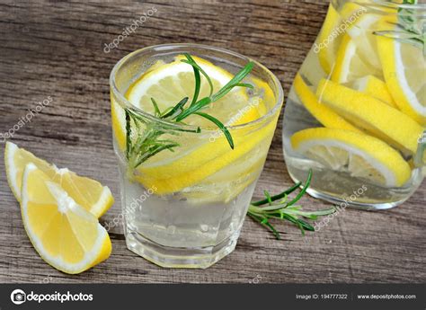 Lemon And Rosemary Detox Water In A Glass On Wood Table