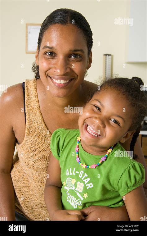 Mom And Daughter Smile While Visiting Doctors Office Or Emergency Room