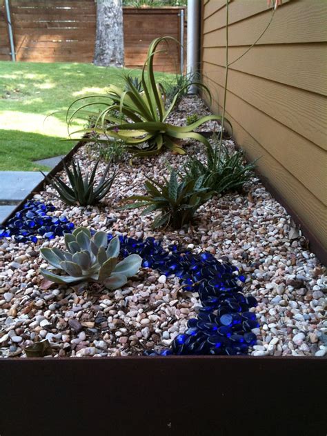 When it comes to the landscaping industry, of course, there are many options available. Steel planter with succulents, river rock and blue glass ...