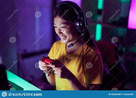 Chinese Woman Streamer Smiling Confident Playing Video Game At Gaming Room Stock Image Image