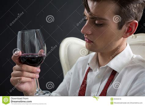 Closeup view of three female young hands holding wineglasses with champagne. Thoughtful Androgynous Man Holding Wine Glass Stock Photo ...