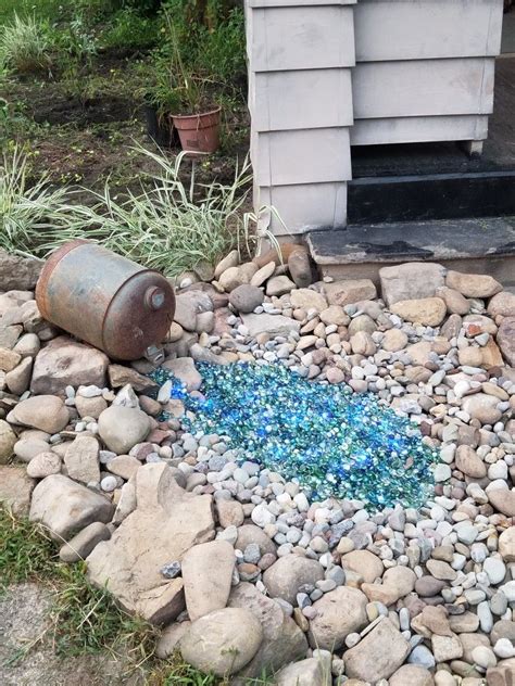 Owning a rock garden can be a great addition to your garden or yard. Our Rock Garden! We used clear, blue, and green glass beads to make it look like water/a pond ...