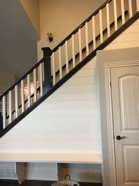 Hayseed Painted Shiplap accent wall with bench. Agreeable gray walls
