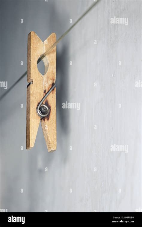 Close Up Vertical Photo Of The Old Wooden Clothes Pin Hanged On A