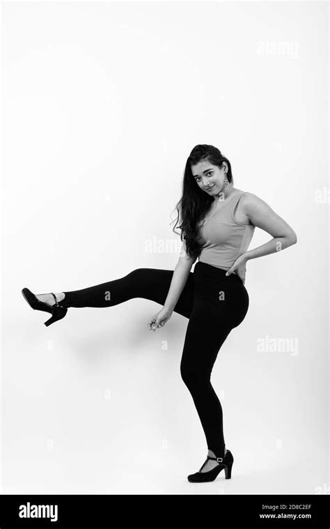 Full Body Shot Of Young Beautiful Indian Woman Posing With One Leg Up