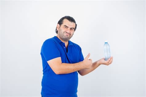 Free Photo Middle Aged Man Holding Water Bottle While Showing Thumb Up In Polo T Shirt And