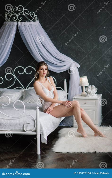 Beautiful Bride In White Lingerie Lying On The Bed In Her Bedroom Stock Photo Image Of