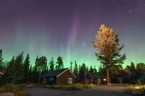 Aurora Borealis Northern Lights Over Wooden Cottage In National Park