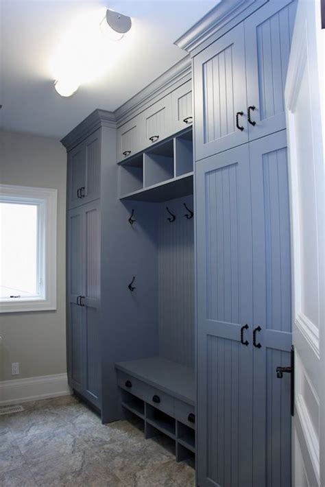 Blue Mudroom With Floor To Ceiling Cabinets And Beadboard Trim Doors