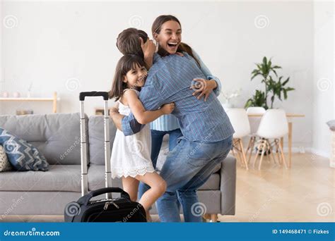 Excited Mom And Daughter Hug Welcome Father Home Stock Image Image Of