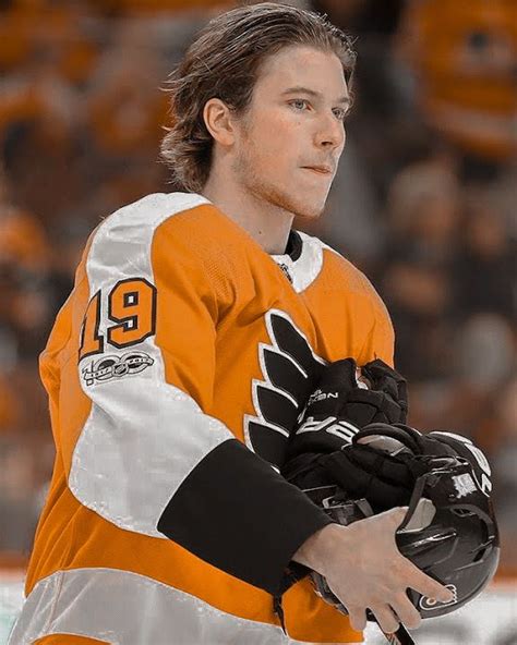 A Man In An Orange And White Jersey Holding A Hockey Glove