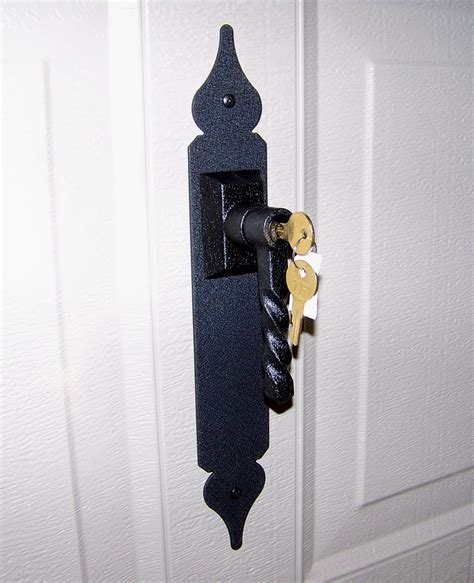 There will be holes in the vertical track that can be used with a simple padlock. Carriage Door Garage Door Lock
