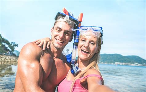 Young Happy Couple In Love Taking Selfie In Tropical Excursion With Water Camera Boat Trip