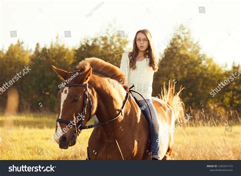 Young Girl Sitting Astride Sorrel Horse Stock Photo 1202341714