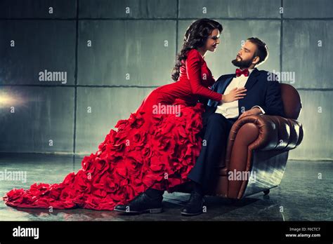 Young Elegant Loving Couple In Evening Dress Portrait Woman In Red And Man In Black Suit