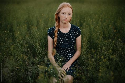 Young Girl Sitting In Field By Stocksy Contributor Sidney Scheinberg