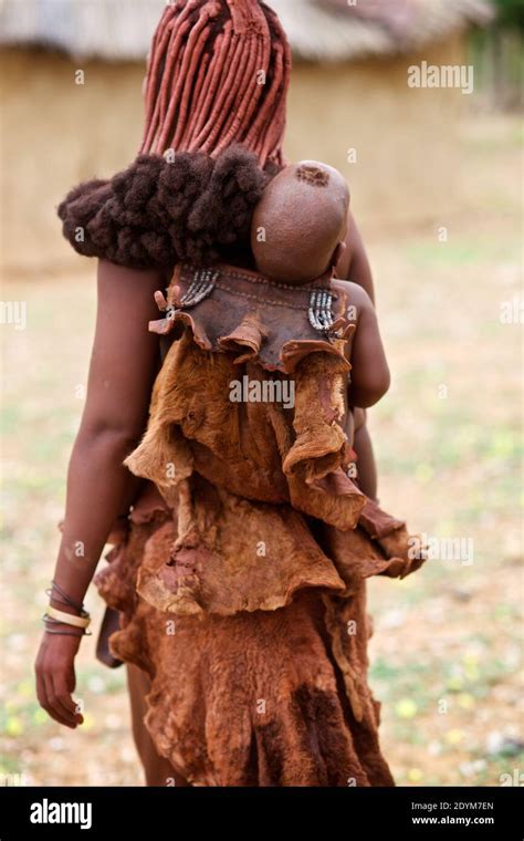 Himba Baby Carried By Woman In Traditional Village Kaokoland Namibia