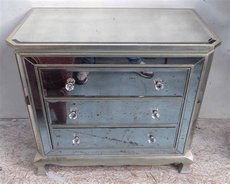Mirrored Chest With A Bevelled Glass Top Above Three Drawers With Glass Handles With Silver
