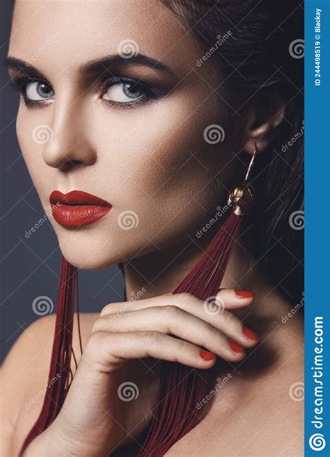 stunning woman with a beautiful makeup wearing long red earrings stock image image of