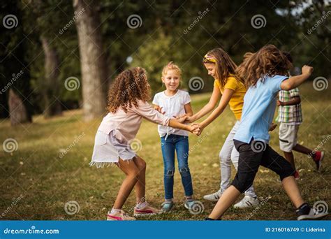 Childhood Large Group Of School Kids Having Fun In Nature Stock Image