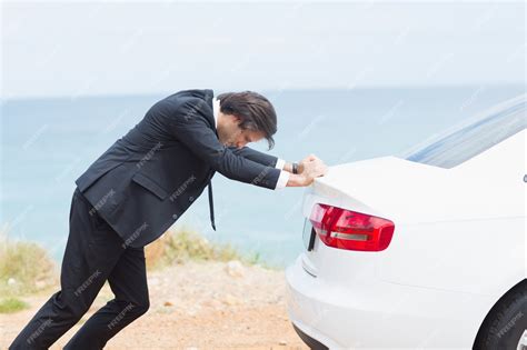 Premium Photo Businessman Pushing His Car